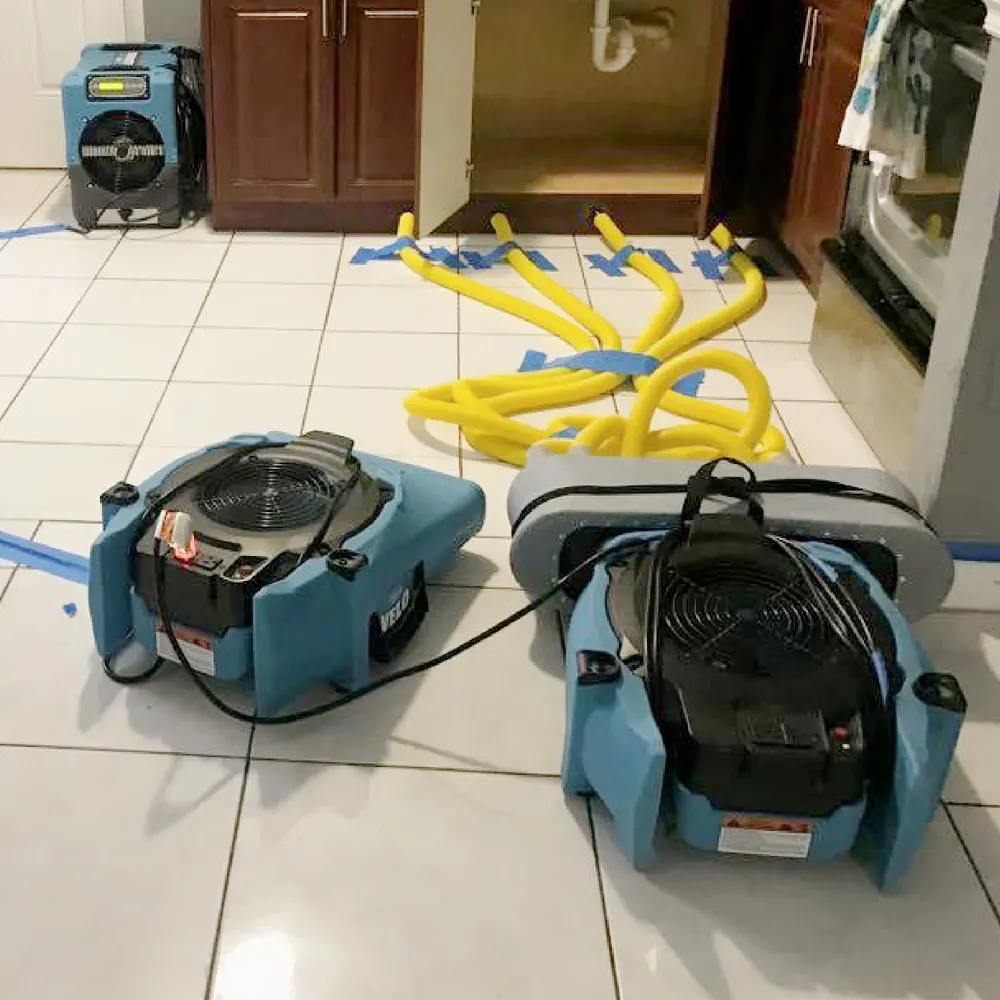 Air movers drying a wet tile floor on a Royal Water Damage job